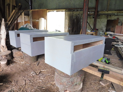 Three hives painted - a light gray-blue