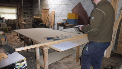 Cian measuring a large 18mm pine board