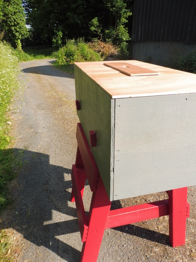 The rear of the hive, showing the lower panel held by some simple turning clamps