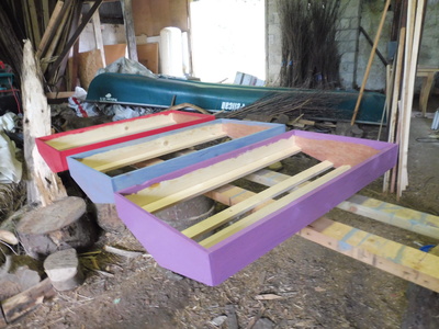 Three painted roof frames - red, blue, and purple